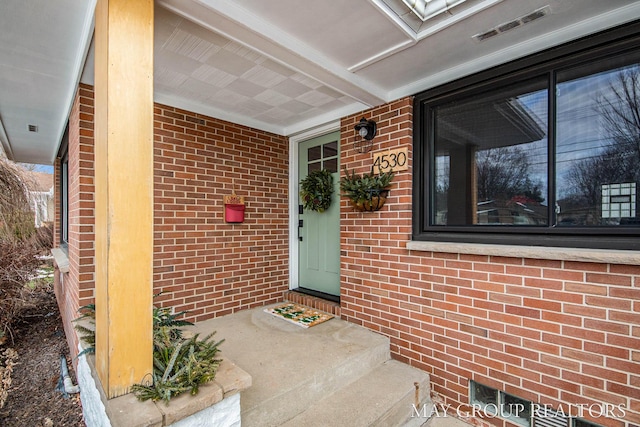 view of exterior entry with covered porch