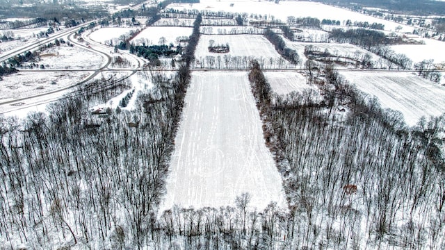 snowy aerial view featuring a rural view