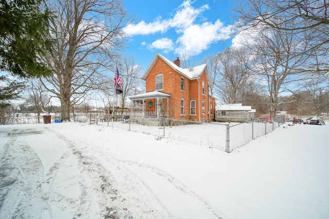 view of snow covered exterior with a porch