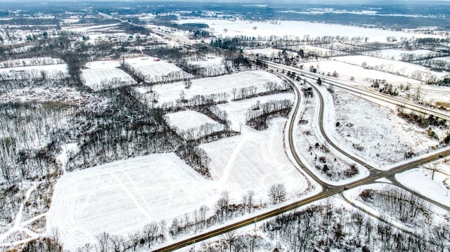 snowy aerial view featuring a rural view