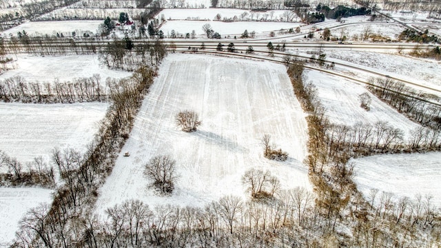 snowy aerial view featuring a rural view