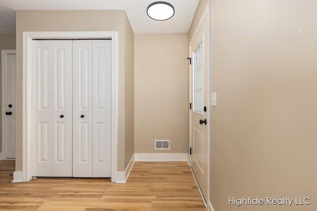 corridor with light wood-type flooring