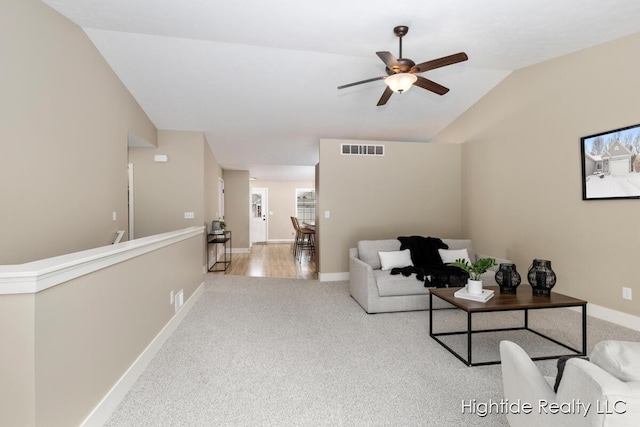 carpeted living room with lofted ceiling and ceiling fan