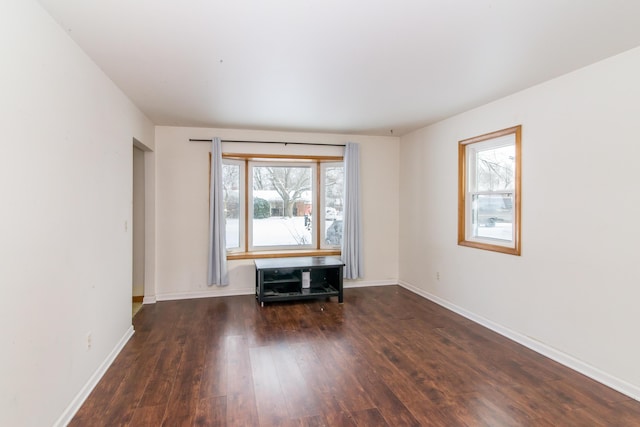 spare room with dark wood-type flooring