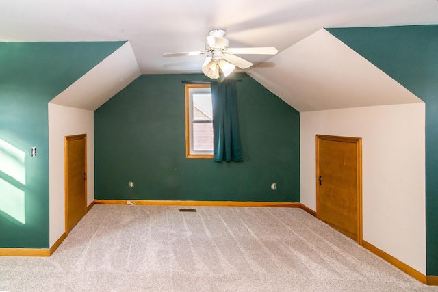 additional living space with lofted ceiling, ceiling fan, and carpet flooring