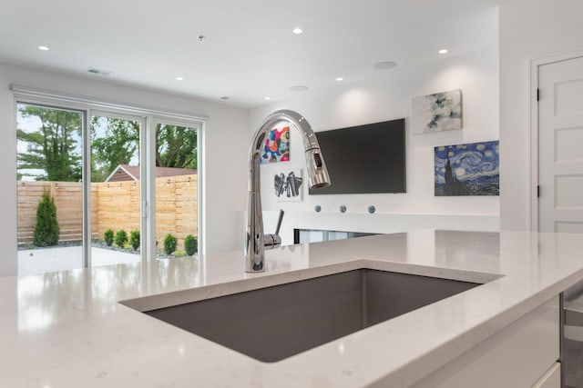 kitchen with sink and light stone countertops