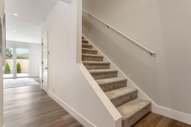 staircase with wood-type flooring