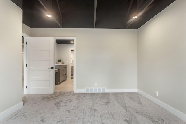 empty room featuring light colored carpet