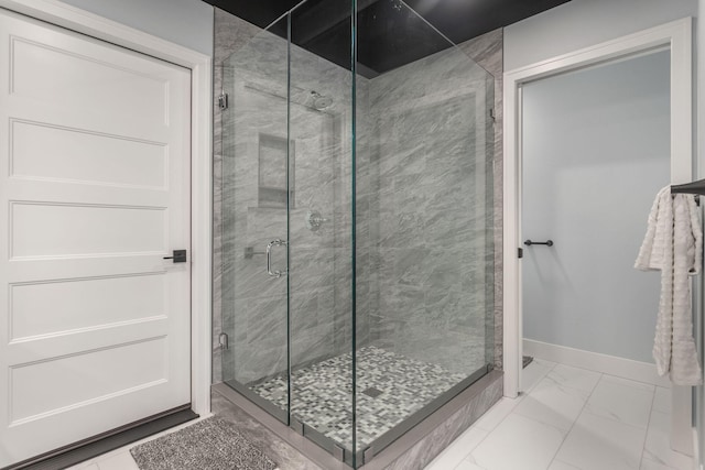 bathroom featuring a shower with shower door