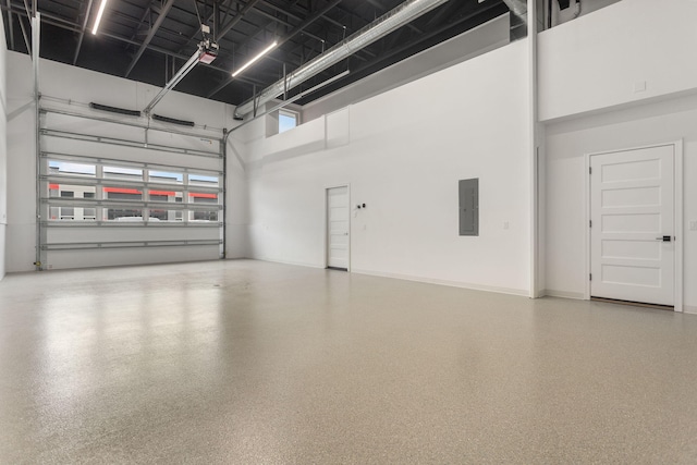 garage with a garage door opener and electric panel