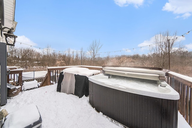 snow covered deck featuring a hot tub