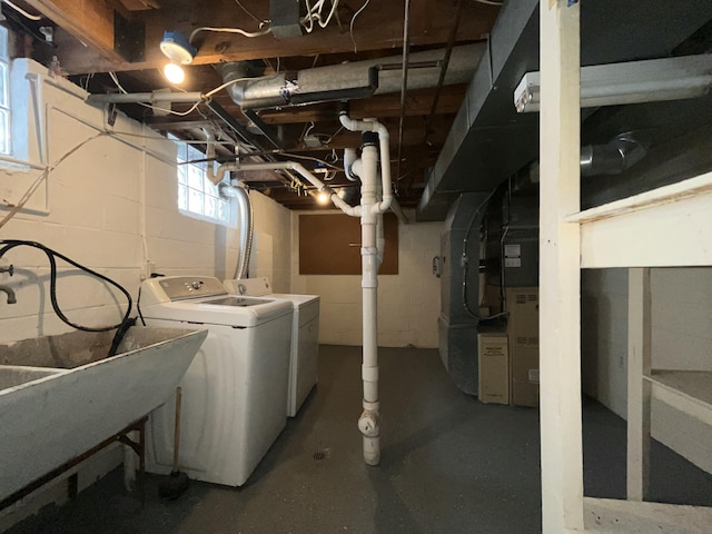 basement featuring washer and dryer and sink