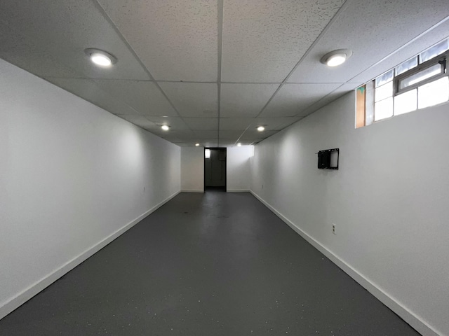 basement with a paneled ceiling