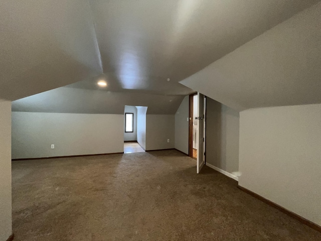 bonus room featuring lofted ceiling and carpet floors