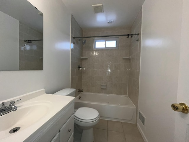 full bathroom with tile patterned flooring, tiled shower / bath, vanity, and toilet