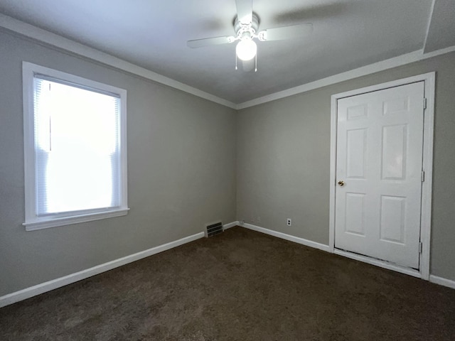 carpeted empty room featuring a wealth of natural light and ceiling fan