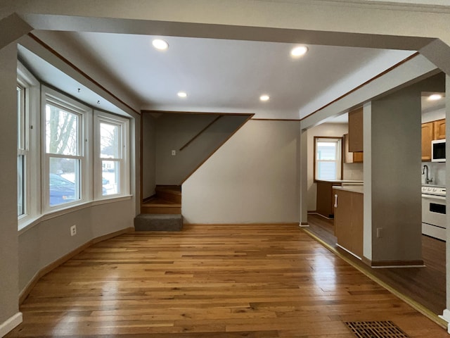 unfurnished living room with light hardwood / wood-style flooring