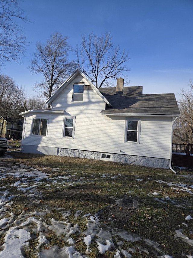 view of snowy exterior featuring a chimney