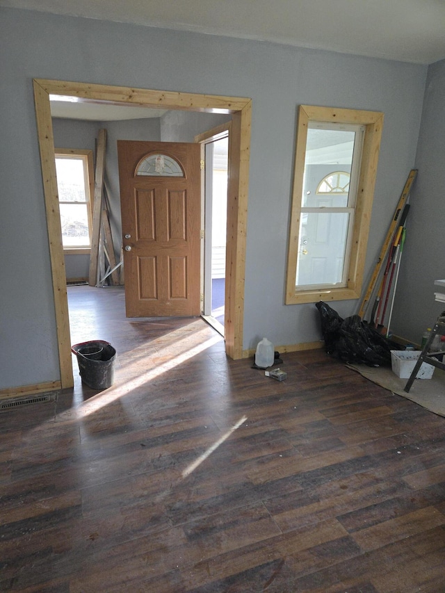 entrance foyer featuring dark wood-style flooring and visible vents