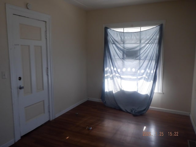 empty room with dark wood-type flooring