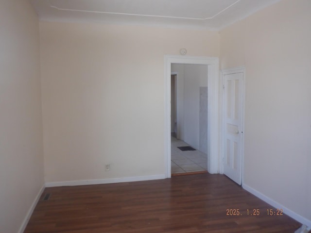 empty room featuring dark wood-type flooring