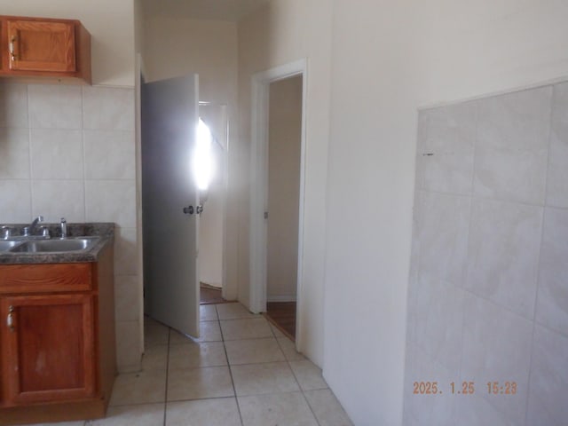 bathroom with tile patterned floors, vanity, and tile walls