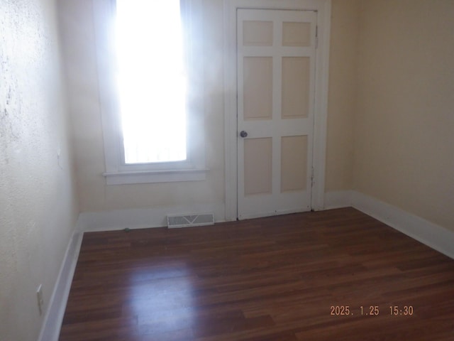 unfurnished room featuring dark wood-type flooring