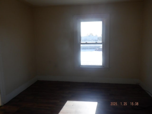 spare room featuring dark hardwood / wood-style flooring