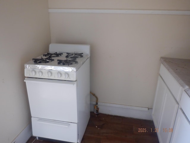 laundry area with dark wood-type flooring