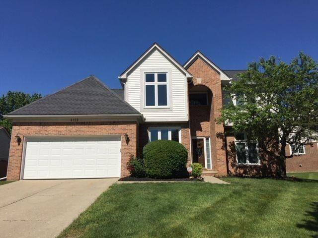 view of front property with a garage and a front yard