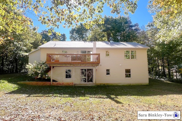 rear view of property with a deck and a lawn