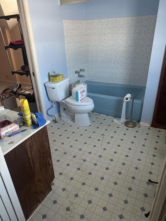 bathroom featuring a tub and toilet