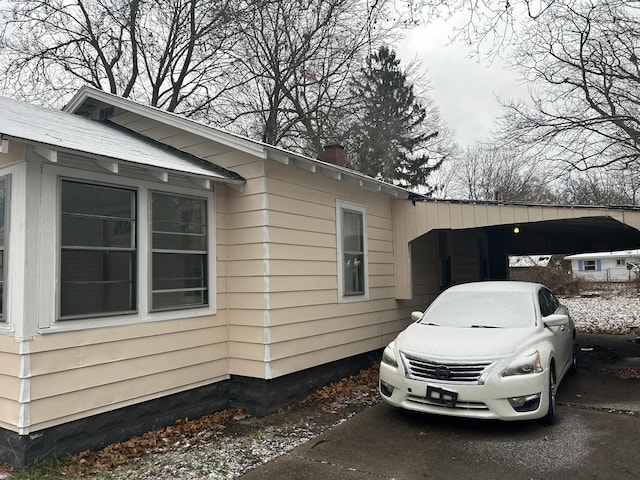 view of side of home featuring a carport