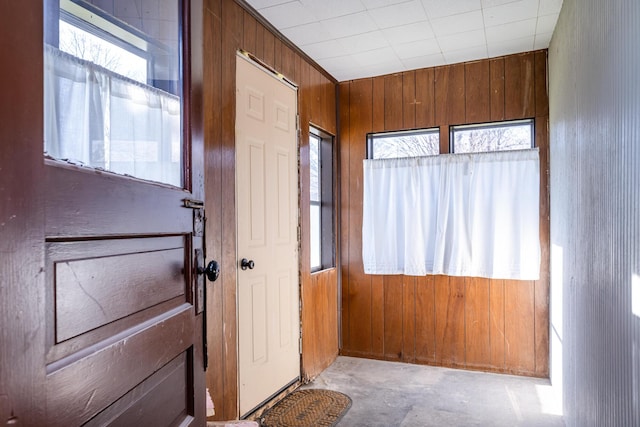 doorway featuring wooden walls