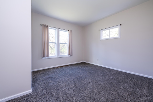 empty room featuring dark colored carpet