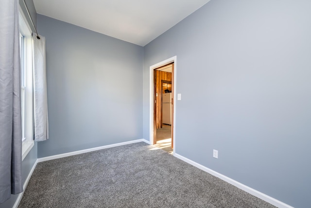 carpeted empty room featuring plenty of natural light