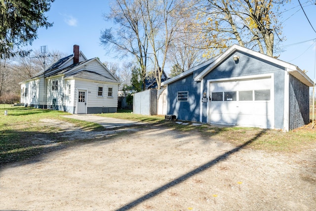 view of side of property featuring a garage and an outdoor structure