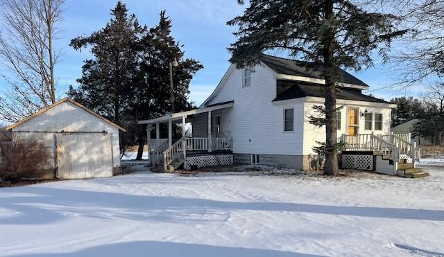 view of front of property featuring a garage and an outdoor structure