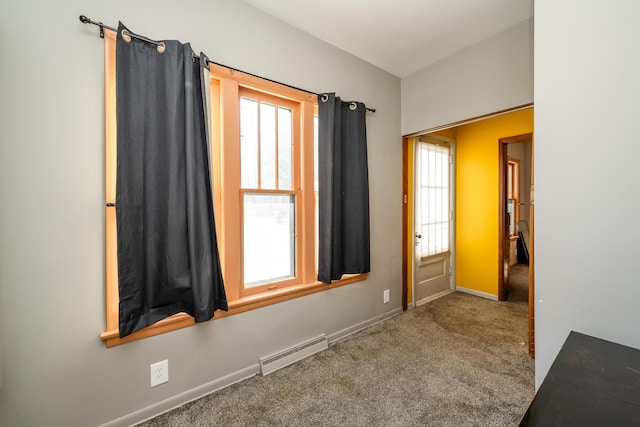 spare room featuring carpet and baseboard heating