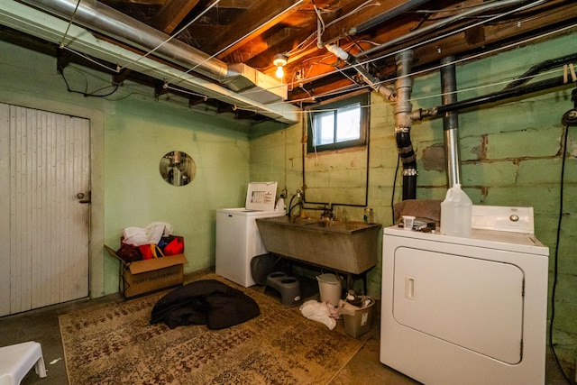 clothes washing area with sink and washer and dryer