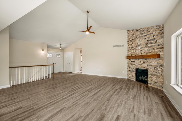 unfurnished living room with ceiling fan, a fireplace, high vaulted ceiling, and wood-type flooring