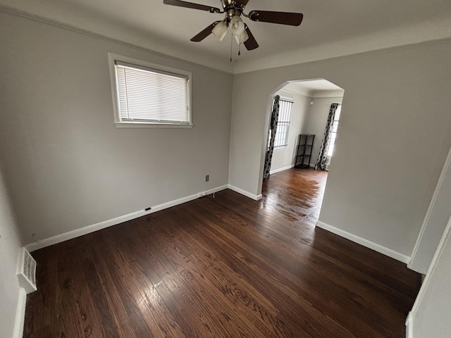 spare room with ornamental molding, ceiling fan, and dark hardwood / wood-style flooring