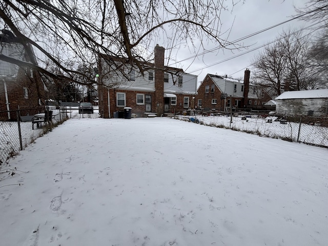 view of snow covered rear of property