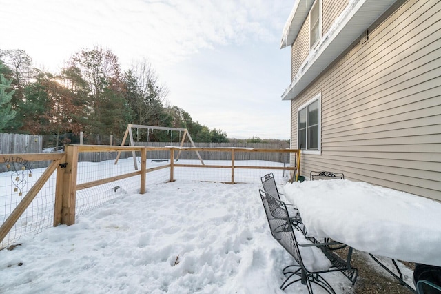 snow covered deck with a playground