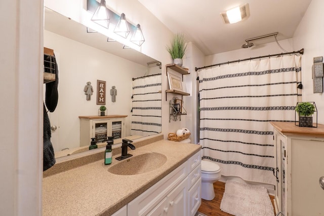 bathroom with vanity, hardwood / wood-style floors, and toilet