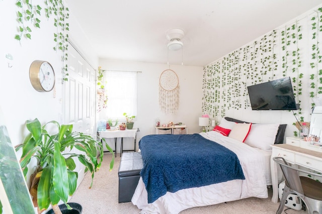 carpeted bedroom with a closet and ceiling fan