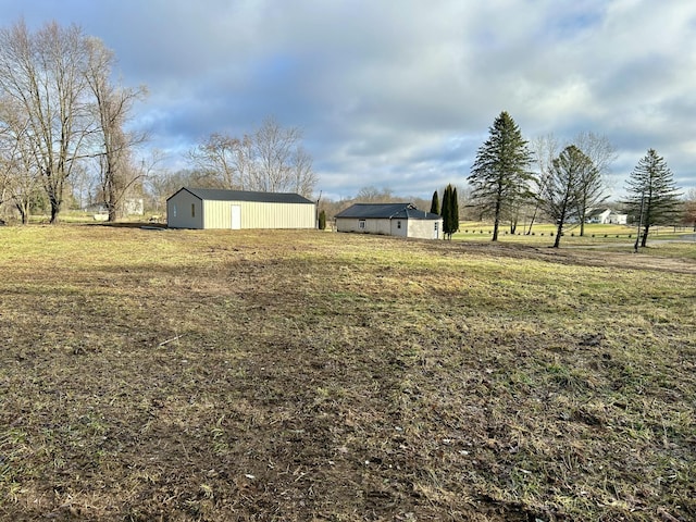 view of yard featuring an outbuilding and a rural view