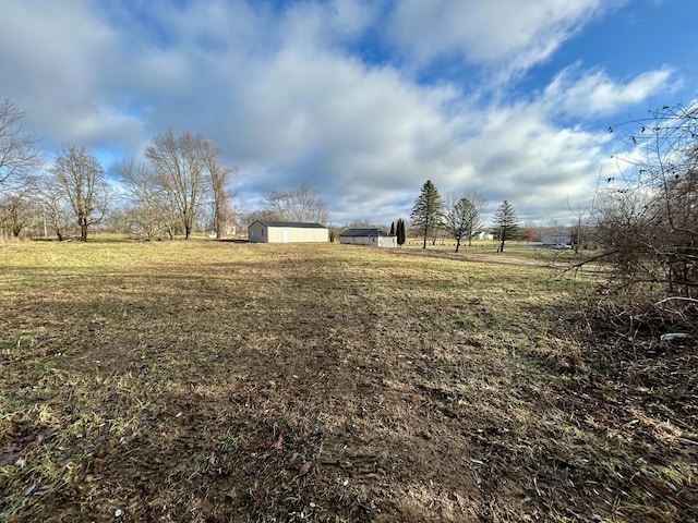 view of yard featuring a storage shed and a rural view