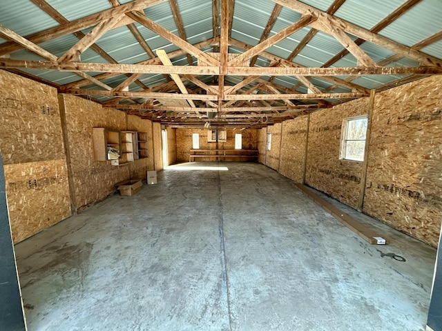 interior space with vaulted ceiling and concrete floors