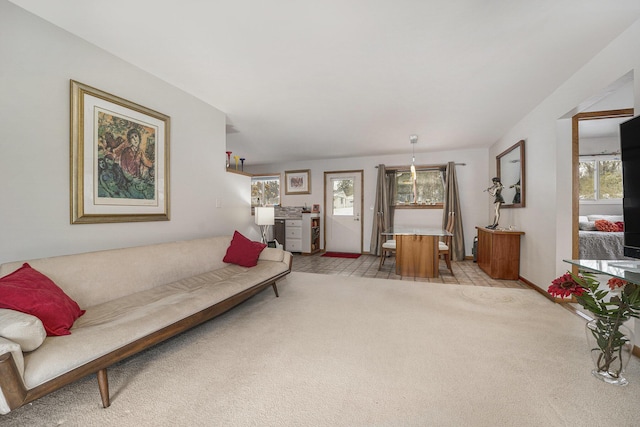 living room with light colored carpet and a healthy amount of sunlight